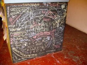 Event attendees write messages on the cube's chalkboard.  